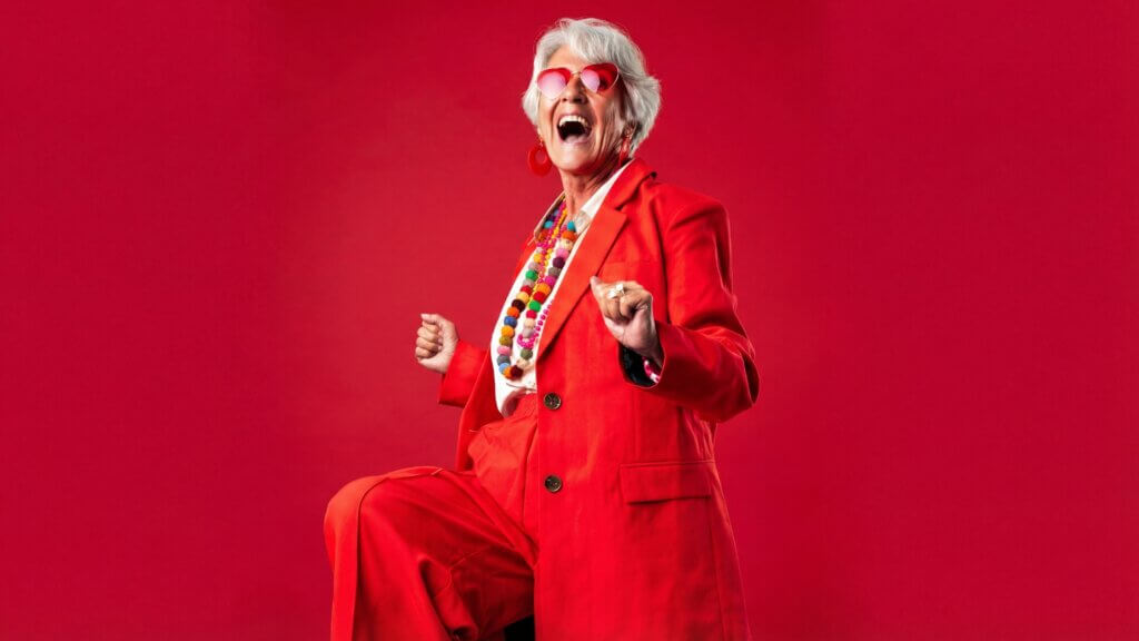 B2B buyers are not rational - behavioural science in marketing. Mature lady in red, dancing.